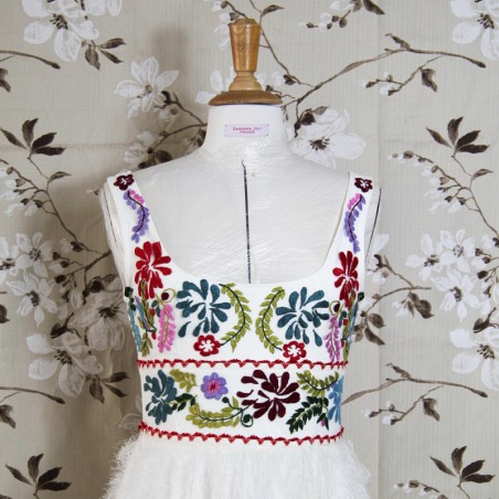 White mi-long sleeveless floral dress with square neckline.