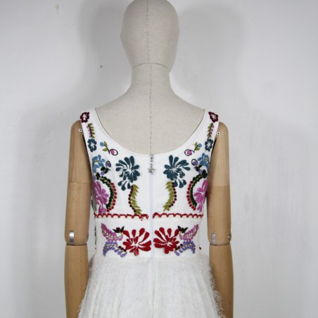 White mi-long sleeveless floral dress with square neckline.