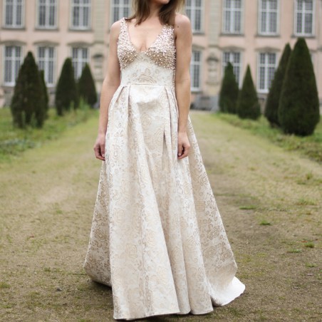 Long sleeveless asymmetrical wedding dress with train